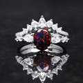Women's sterling silver black fire opal bridal set shown straight on, with pear-cut white side stones