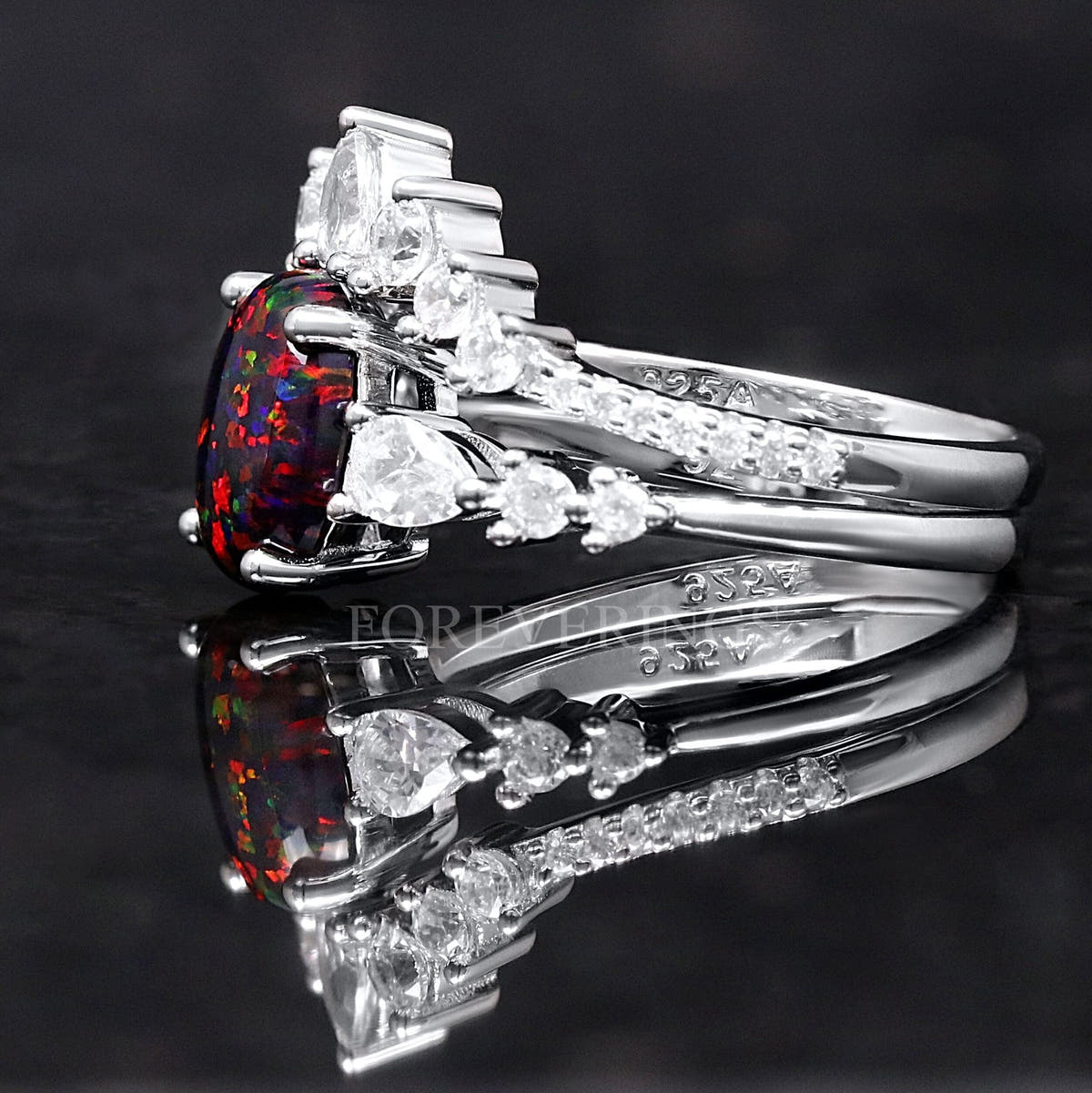 Black fire opal bridal set in sterling silver, side view with the curved band nested against the ring