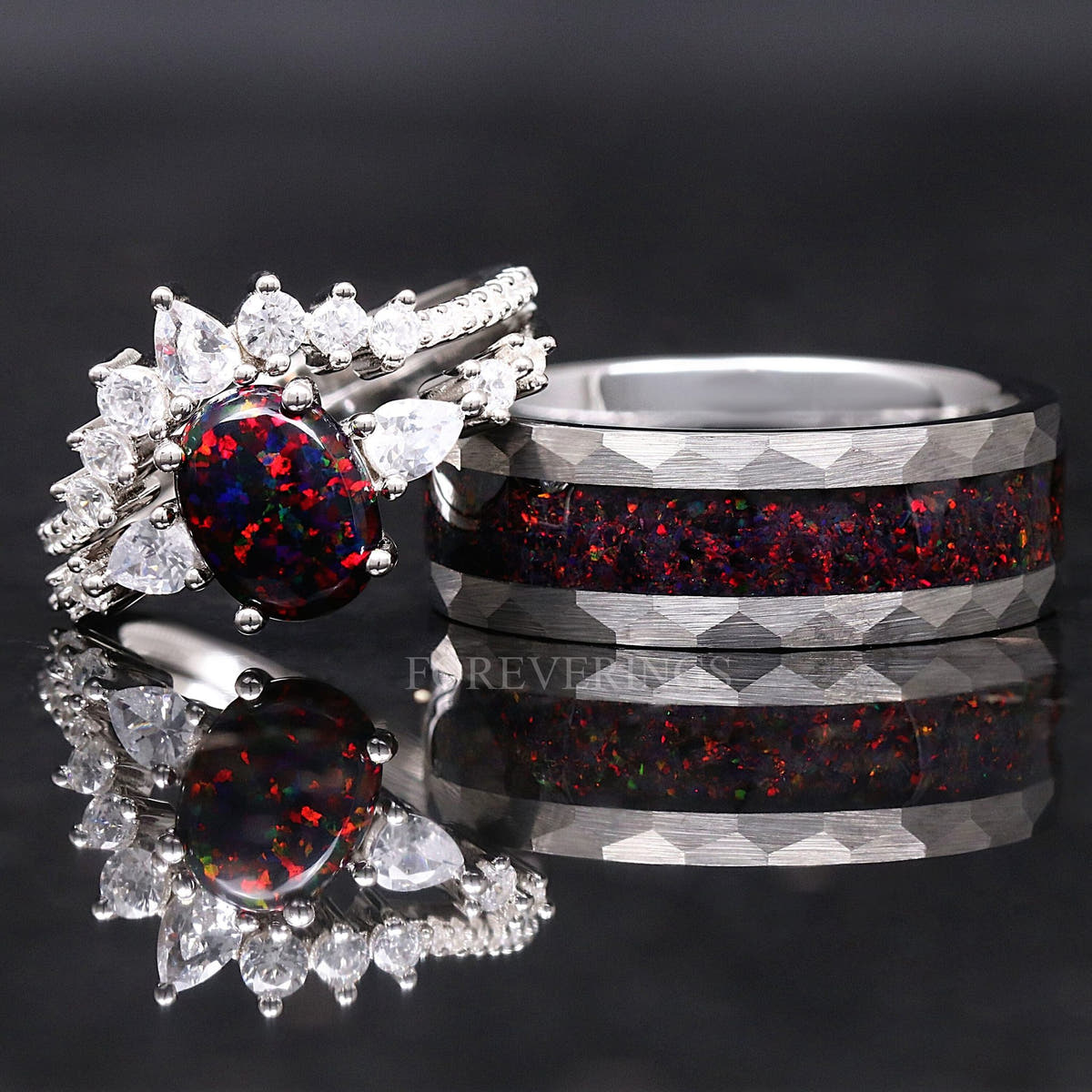 Silver couples ring set from a wider angle: black fire opal bridal set beside the hammered tungsten band