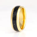 Men's 8mm gold tungsten ring with black onyx inlay standing upright, polished dome