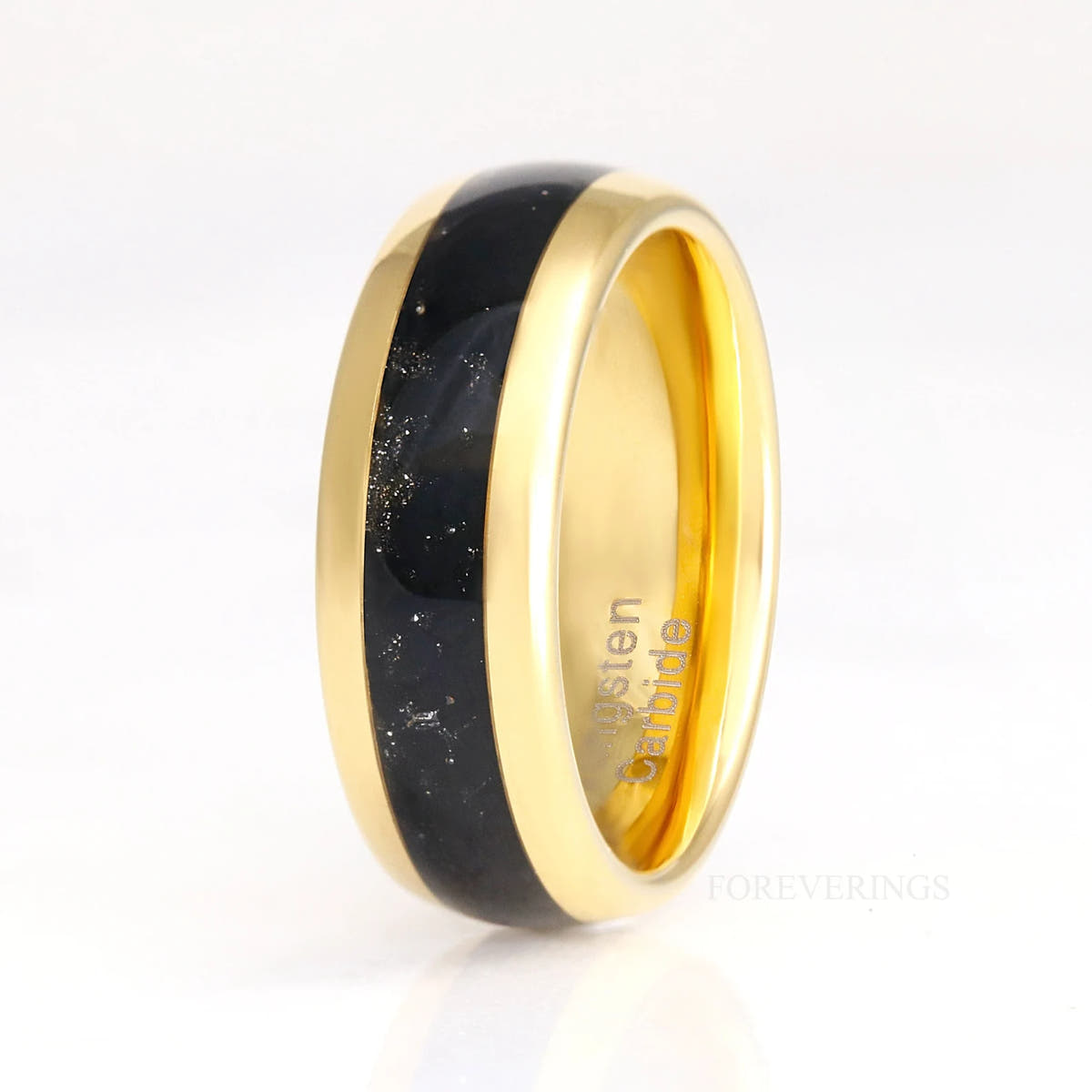 Men's 8mm gold tungsten ring with black onyx inlay standing upright, polished dome