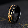 Men's 8mm black tungsten band with citrine inlay and a thin gold line, angled view