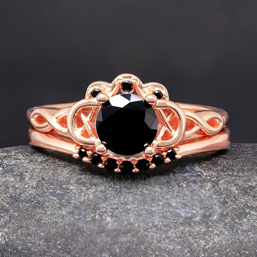 Rose gold Celtic knot engagement ring with a round black diamond center stone and a curved band of black accents
