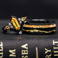 Matching black couples ring set with a hexagon citrine engagement ring and citrine inlay band