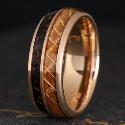 Men's 8mm rose gold tungsten band with whiskey barrel wood and coffee inlay, angled view