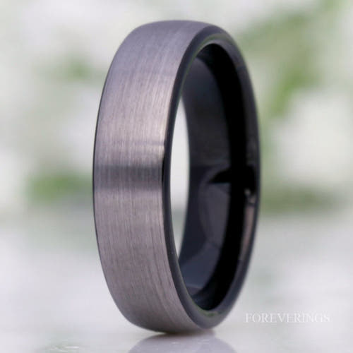 Men's 6mm brushed silver tungsten wedding band with a black interior, standing upright