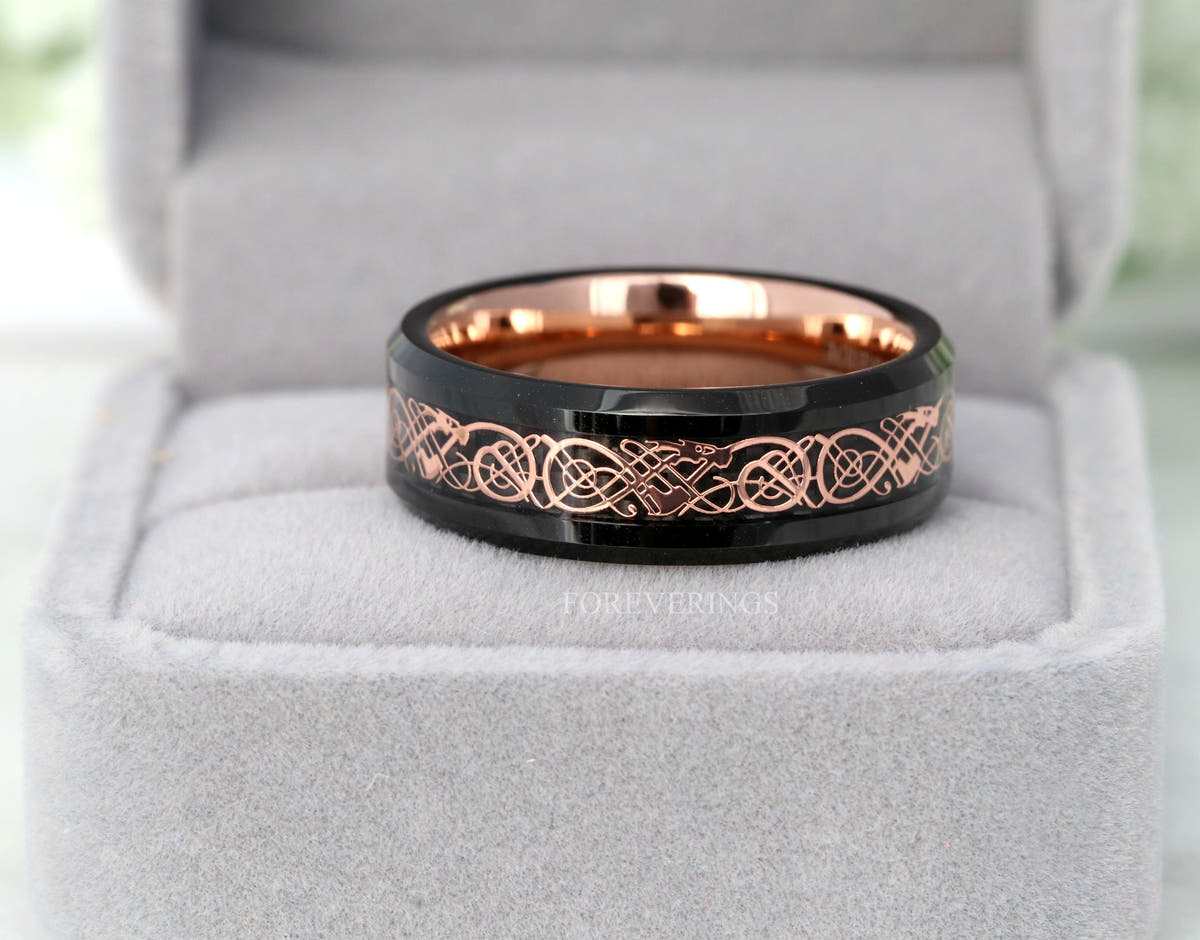 Black and rose gold tungsten Viking dragon ring in a gray ring box