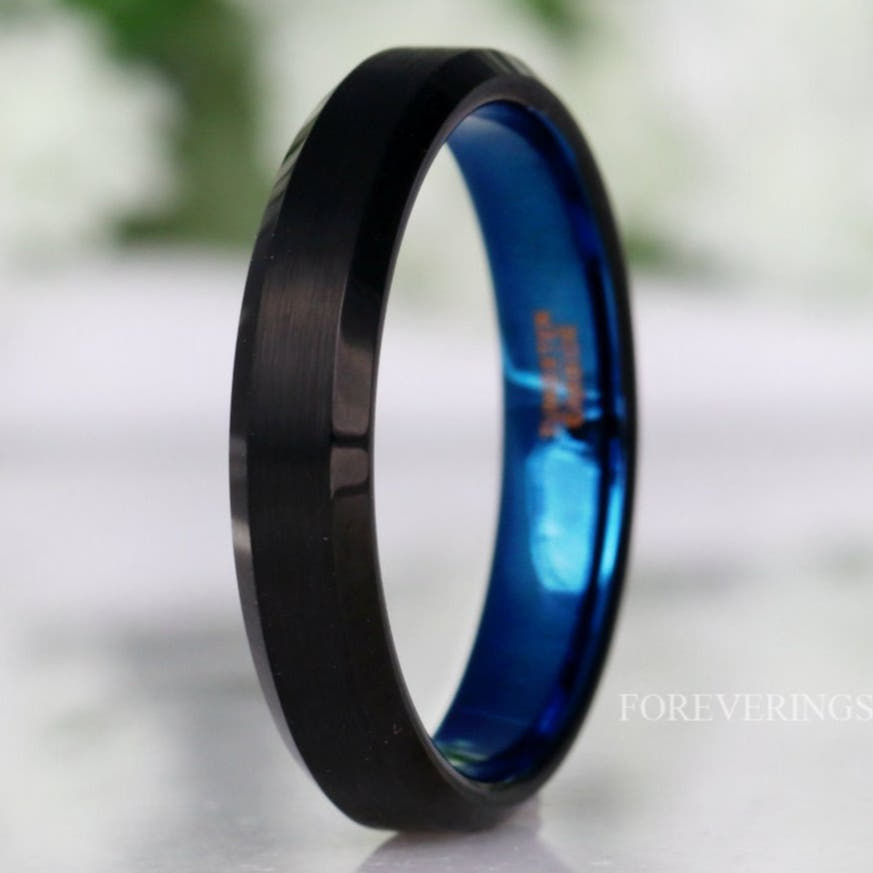 4mm matte black tungsten ring with a blue interior and beveled edges, standing upright