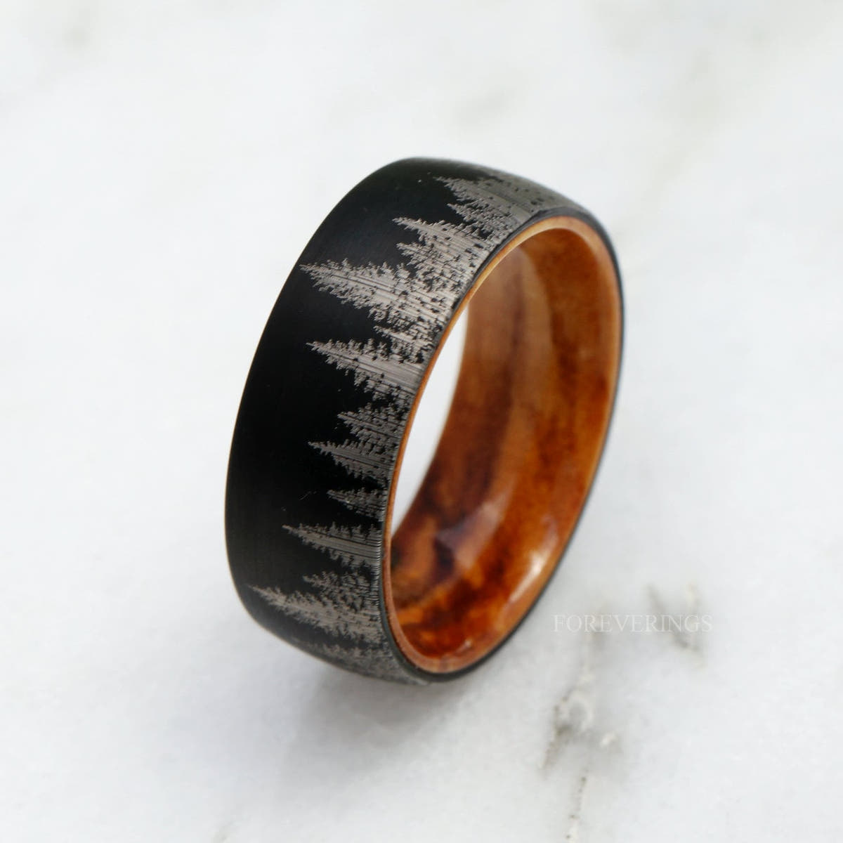 Black tungsten pine tree band with olive wood interior, angled view from above