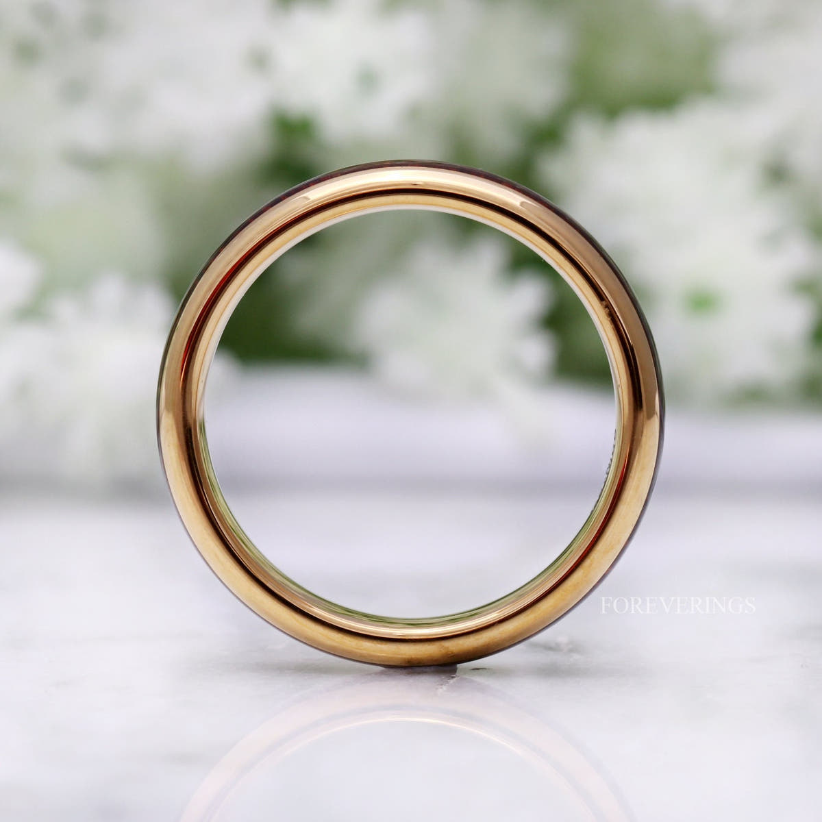 Gold tungsten koa wood band viewed head-on through the center