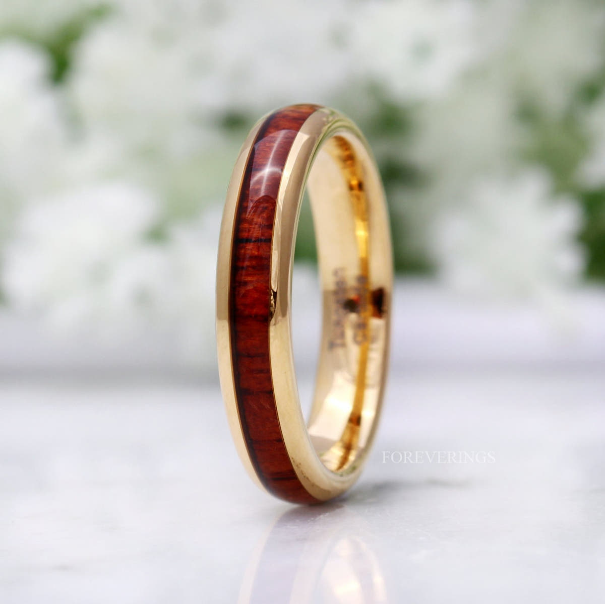 Gold tungsten option of the 4mm koa wood band, standing angled toward the interior