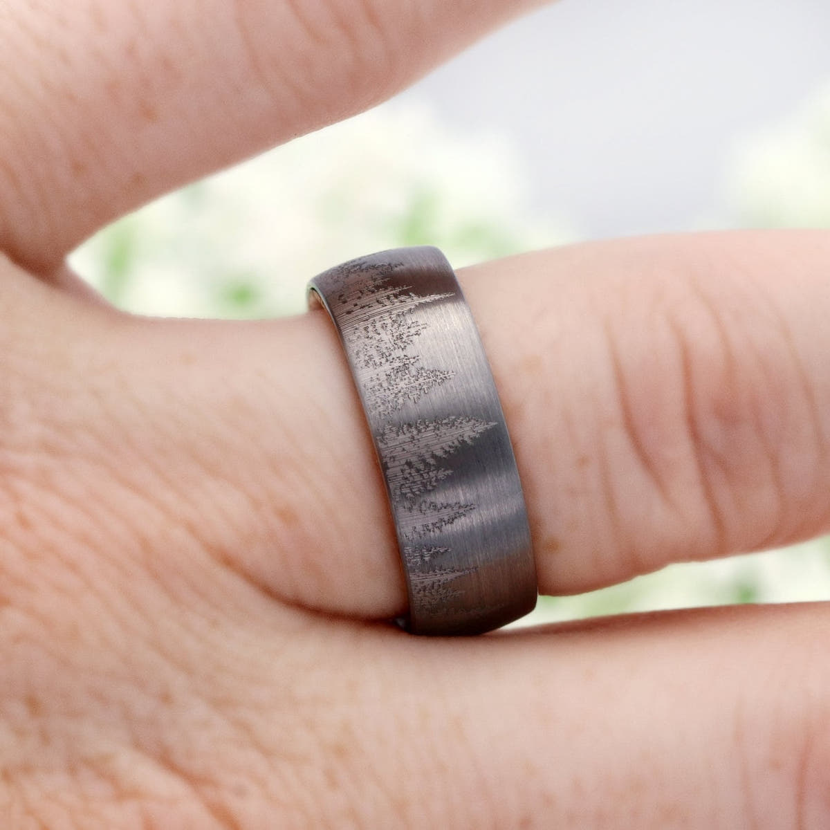 8mm silver tungsten forest tree-line band worn on a finger