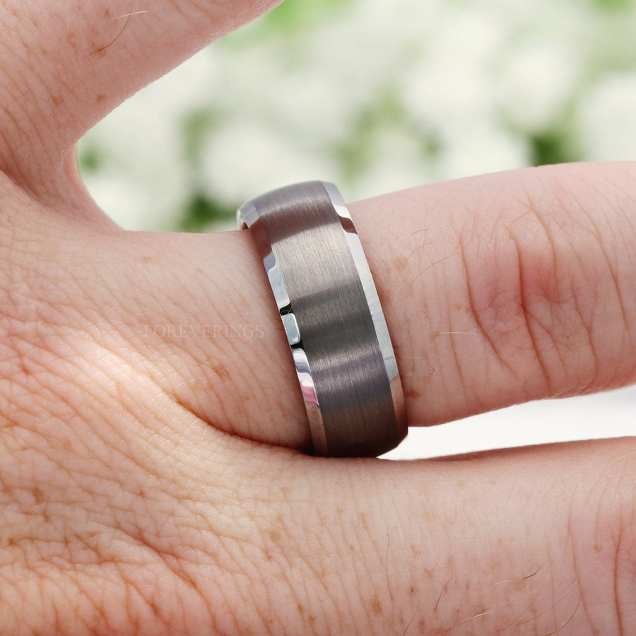 8mm silver tungsten whiskey barrel band worn on a finger