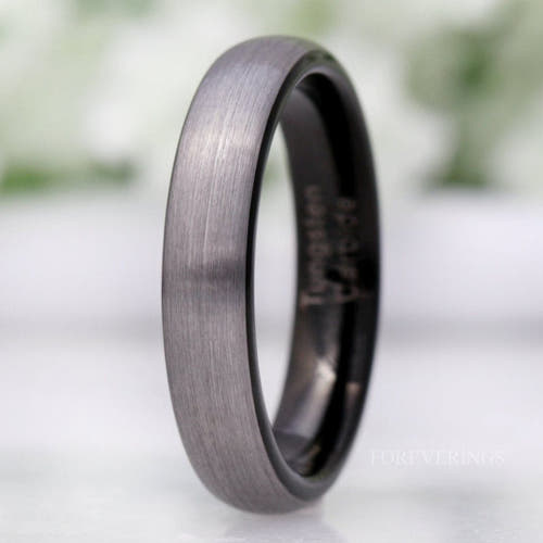 4mm brushed silver tungsten wedding band with black interior, domed, standing at an angle