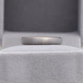 4mm matte silver tungsten dome band shown in a gray velvet ring box