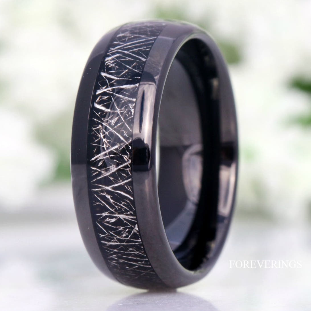 Men's 8mm black tungsten band with meteorite-look inlay, close crop of the polished dome