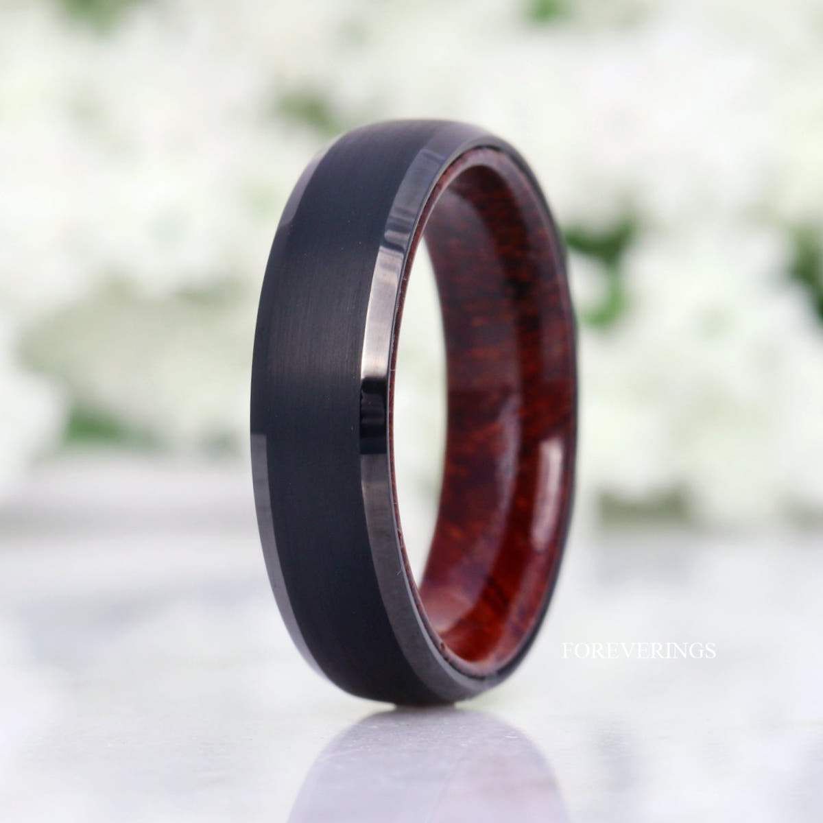 6mm brushed black tungsten wedding band with rosewood interior, standing at an angle