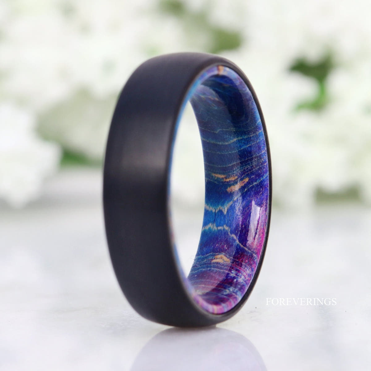 Black tungsten band with blue, violet and pink tones in the elder wood lining