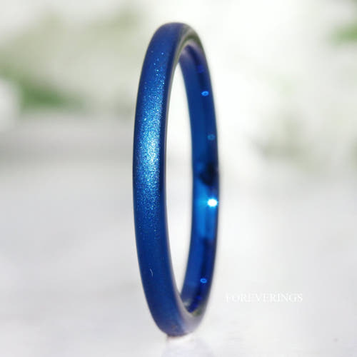 Women's 2mm sparkling blue sandblasted tungsten wedding band standing at an angle