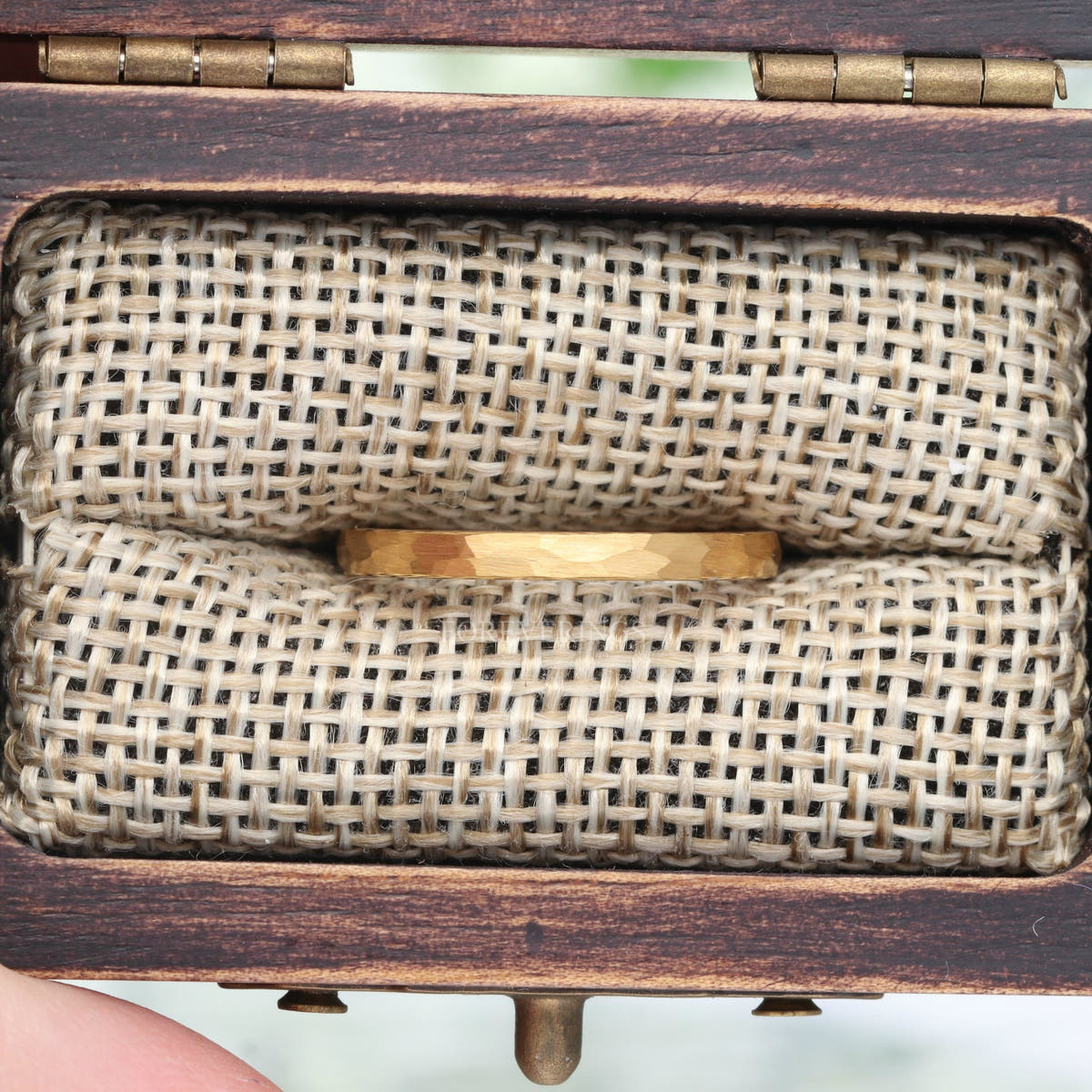 2mm hammered gold tungsten ring in a rustic wood ring box with burlap insert