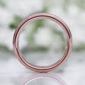 His 6mm tungsten band viewed straight through the center, showing the rose gold interior