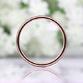 Her 2mm tungsten band viewed straight through the center to show the rose gold inside