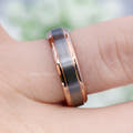 Men's 6mm brushed silver and rose gold tungsten band worn on a finger