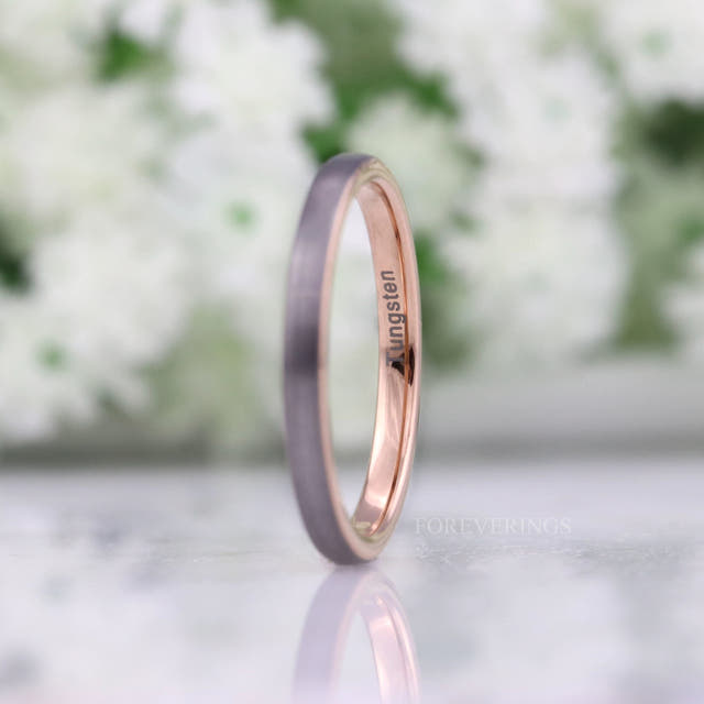 Her 2mm brushed silver tungsten band with rose gold interior, standing at an angle