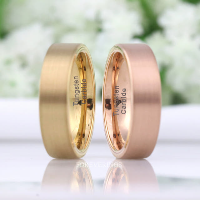 Gold and rose gold brushed tungsten bands side by side, turned to show the inside
