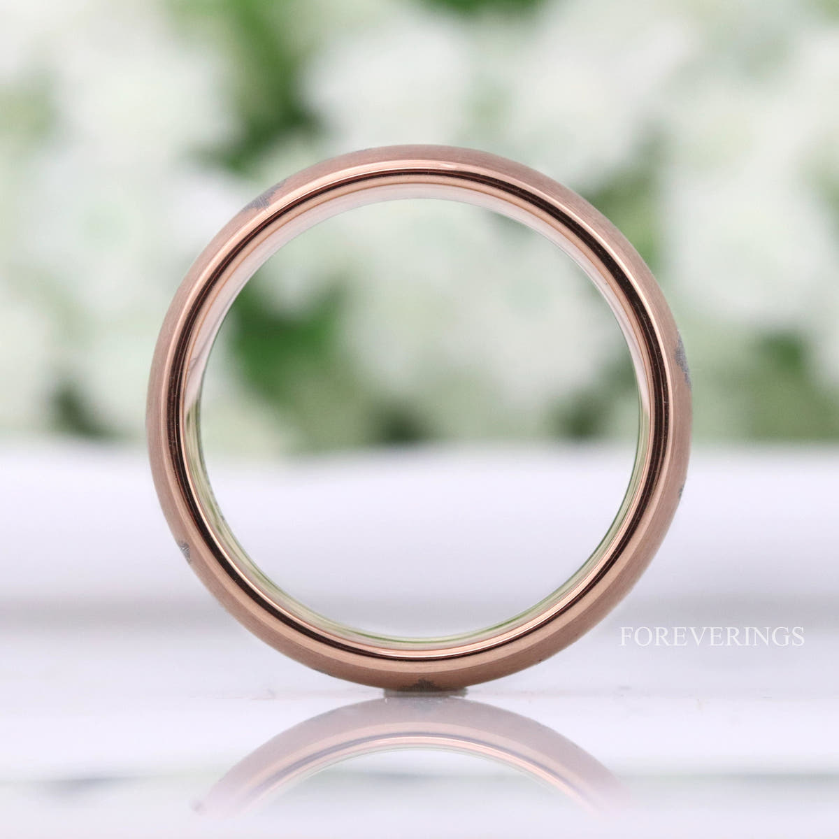 Rose gold tungsten band viewed straight through the center, rose gold interior