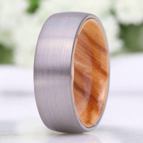 Men's 8mm brushed silver tungsten wedding band with an olive wood sleeve inside