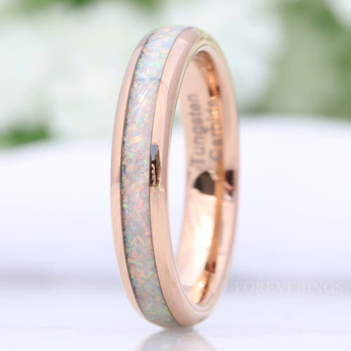 Women's 4mm rose gold tungsten ring with crushed white fire opal inlay, close-up angled view