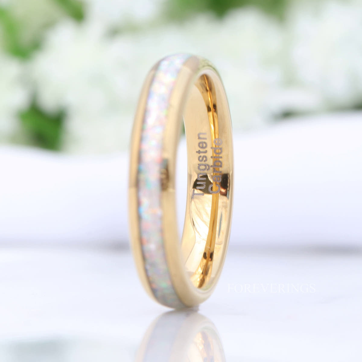 4mm gold tungsten ring with white fire opal inlay standing upright, wider view