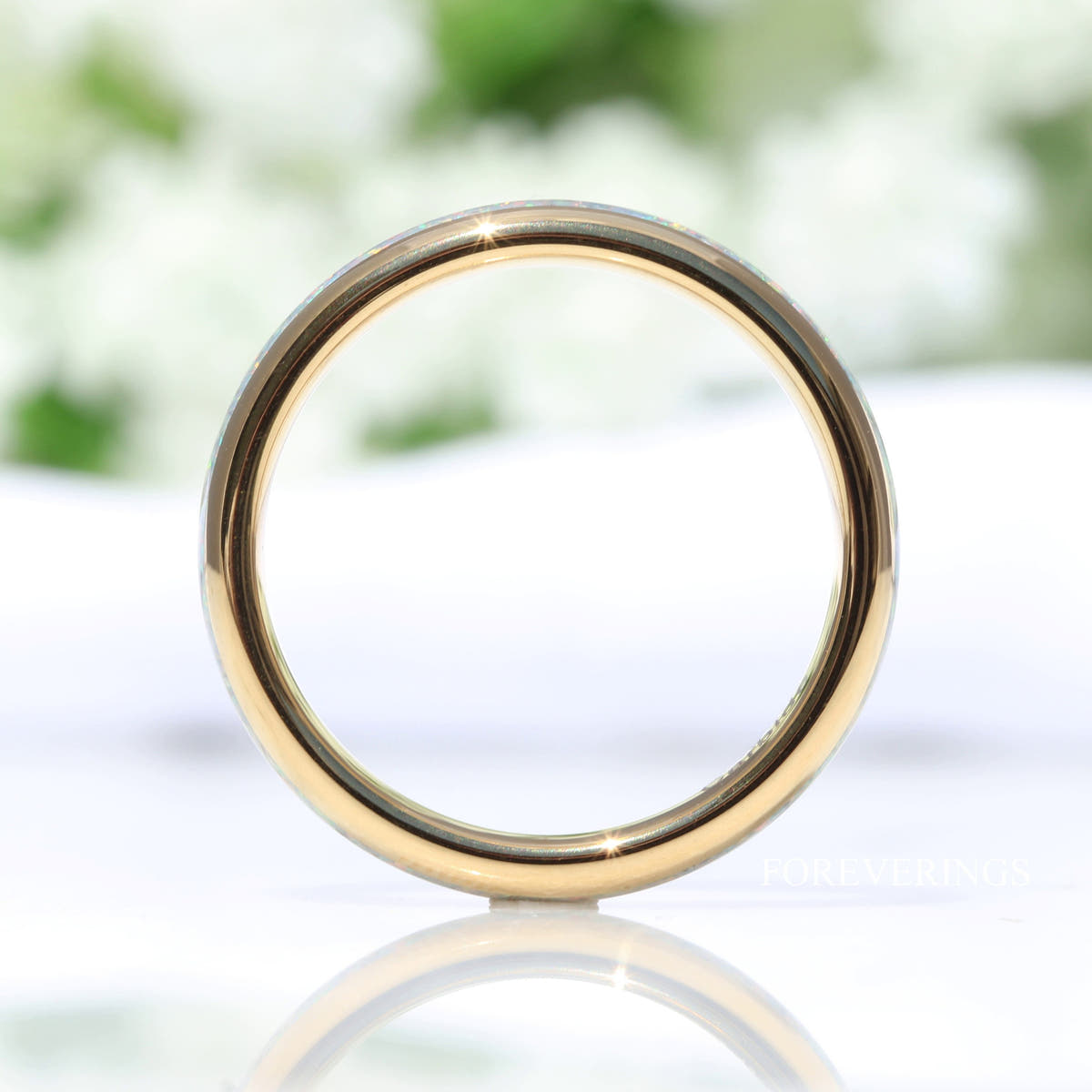 4mm gold tungsten band viewed edge-on, showing its round shape and polished rim