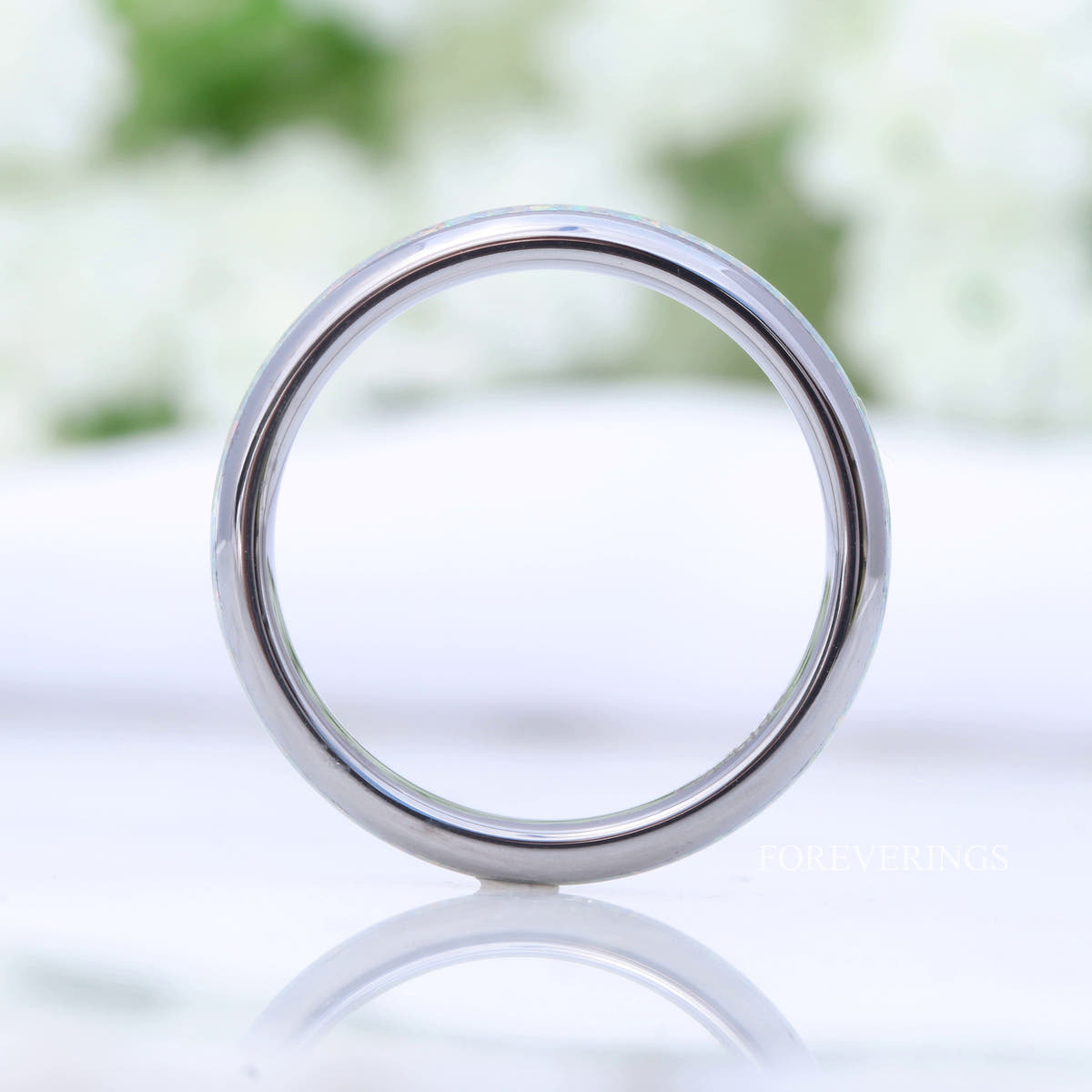 4mm silver tungsten opal ring standing on edge, seen as a full circle