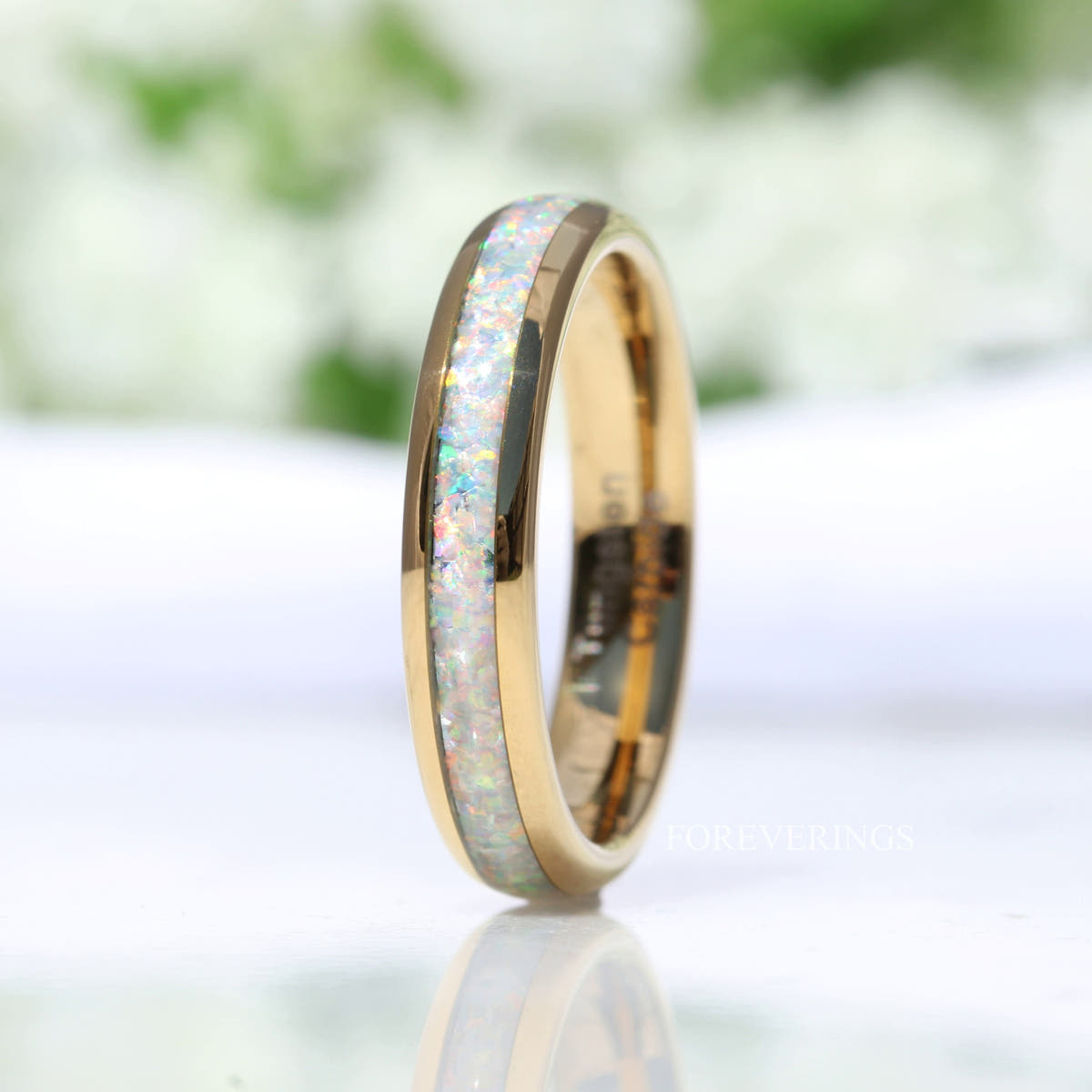 White fire opal gold tungsten ring turned to show the polished gold interior