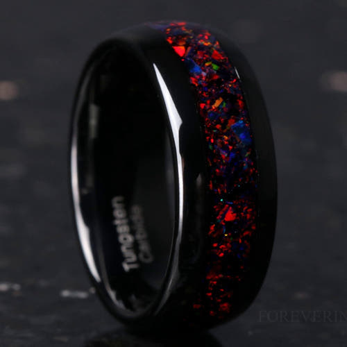 Men's black tungsten wedding band with black fire opal inlay, polished dome, standing at an angle