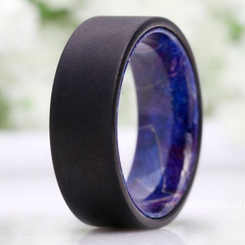 Men's 8mm sandblasted black tungsten band with blue elder wood interior, close crop