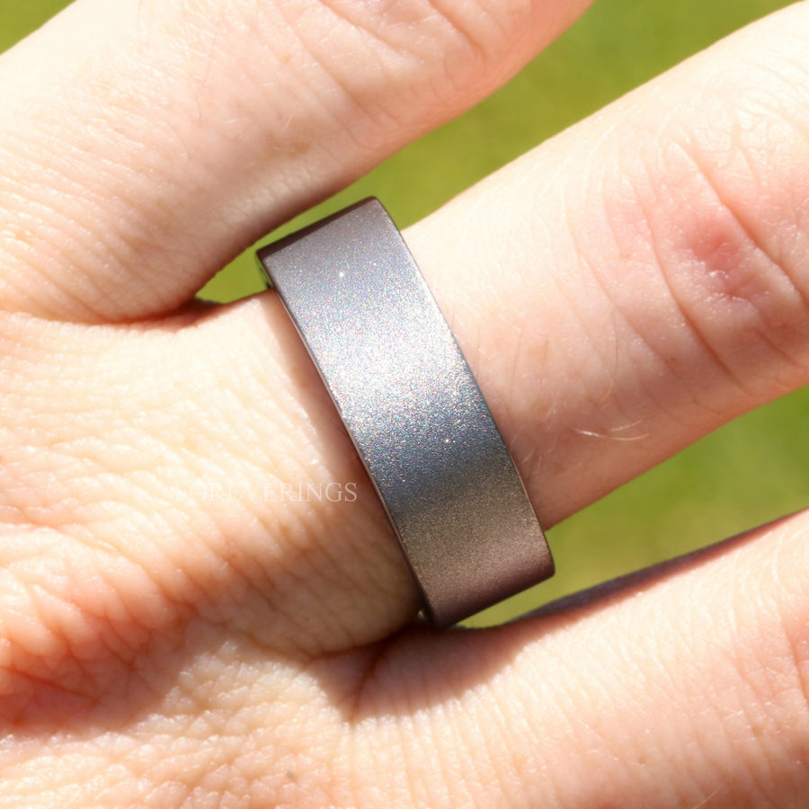 8mm sandblasted silver tungsten wood-lined band worn on a finger
