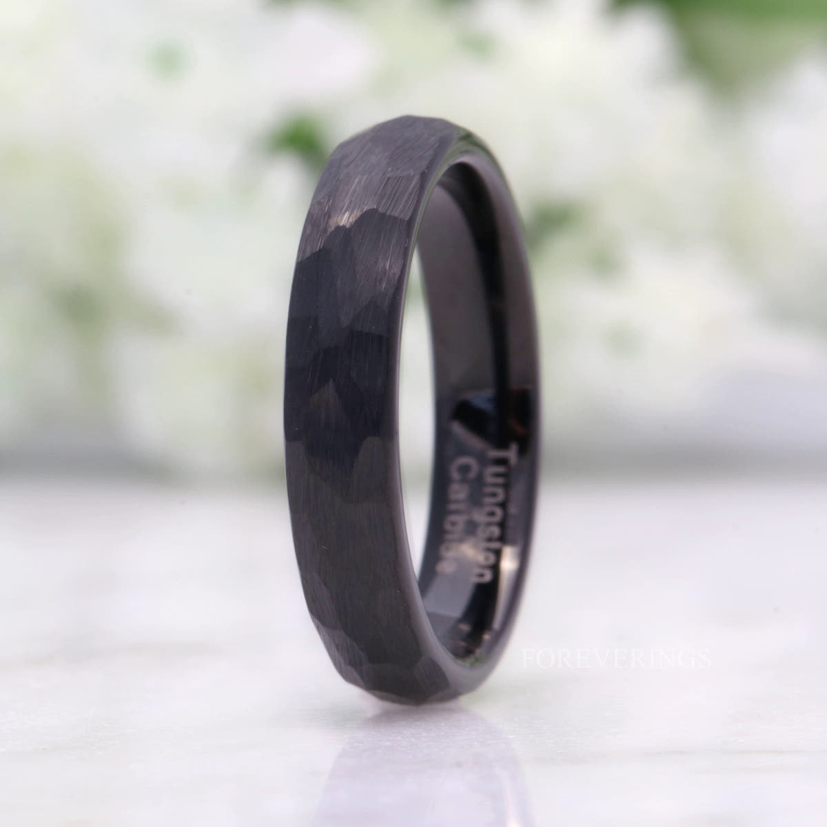 4mm hammered matte black tungsten band standing upright, angled