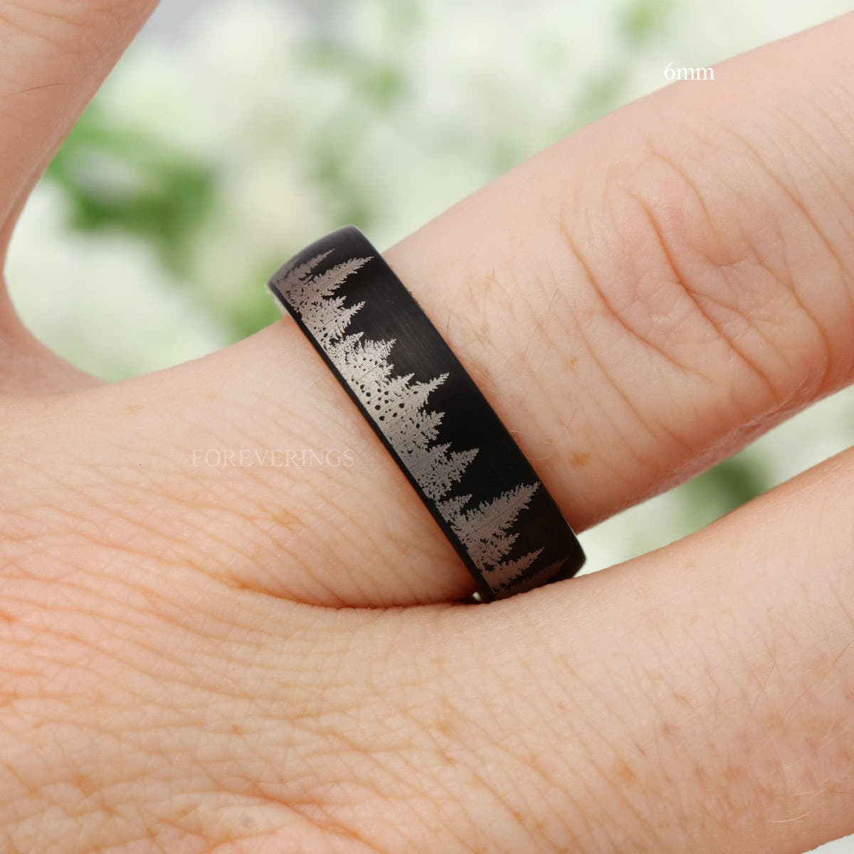 6mm matte black tungsten forest band worn on a finger, side view