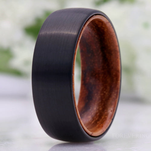 Men's 8mm brushed black tungsten wedding band with a zebra wood sleeve, domed