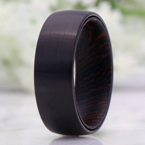 Men's 8mm brushed black tungsten wedding band with a dark wenge wood sleeve, domed
