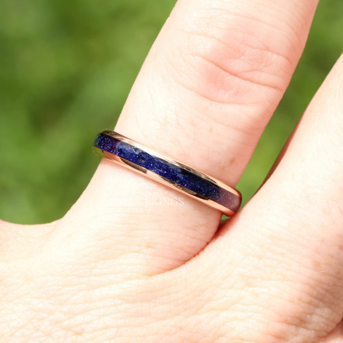 4mm rose gold tungsten ring with blue sandstone inlay, worn on a finger