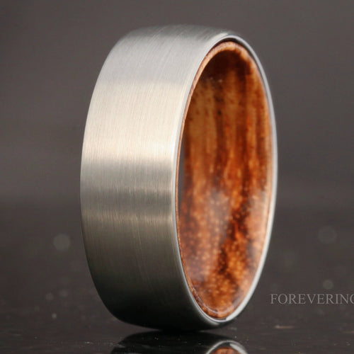 Men's 8mm brushed silver tungsten wedding band with a zebra wood sleeve inside
