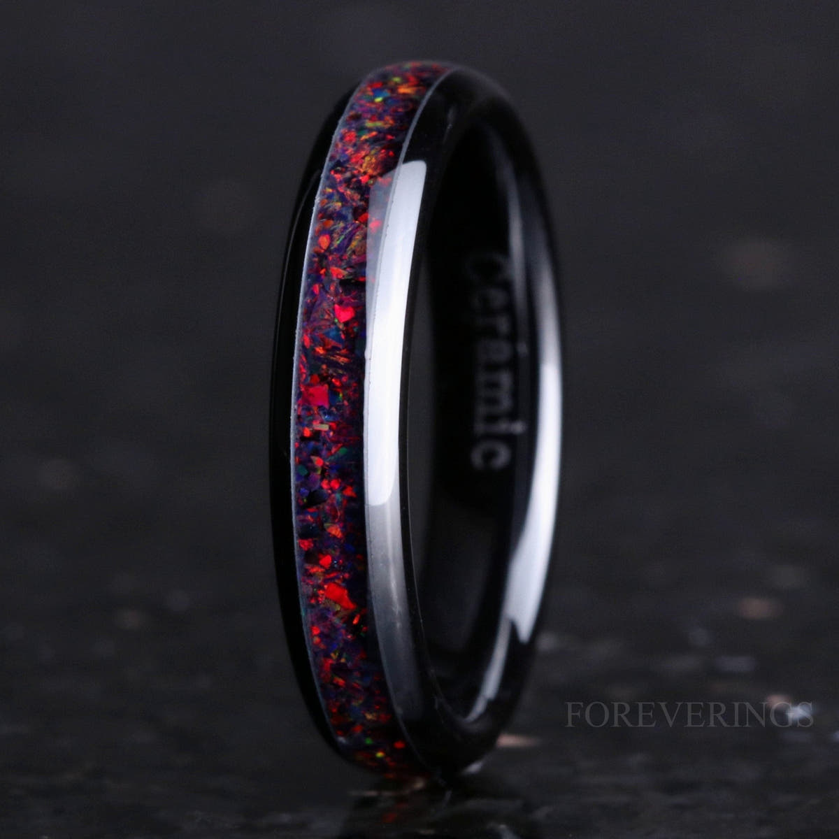 4mm black ceramic ring with black fire opal inlay, standing angled to show the interior