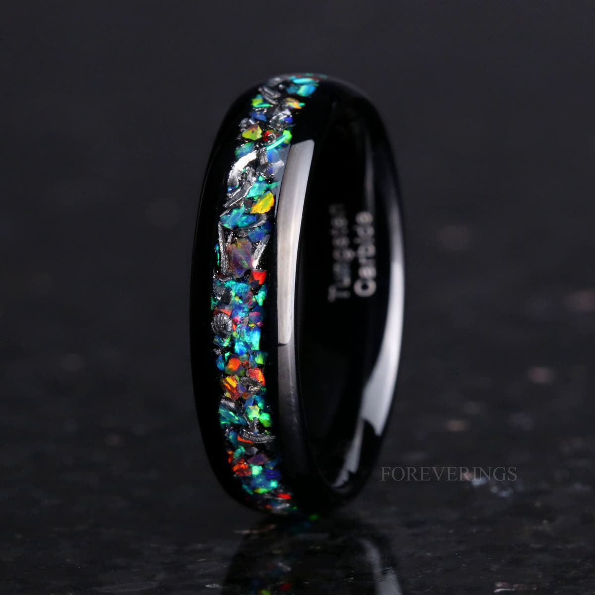 Men's 6mm polished black tungsten band with meteorite and galaxy opal inlay, standing at an angle