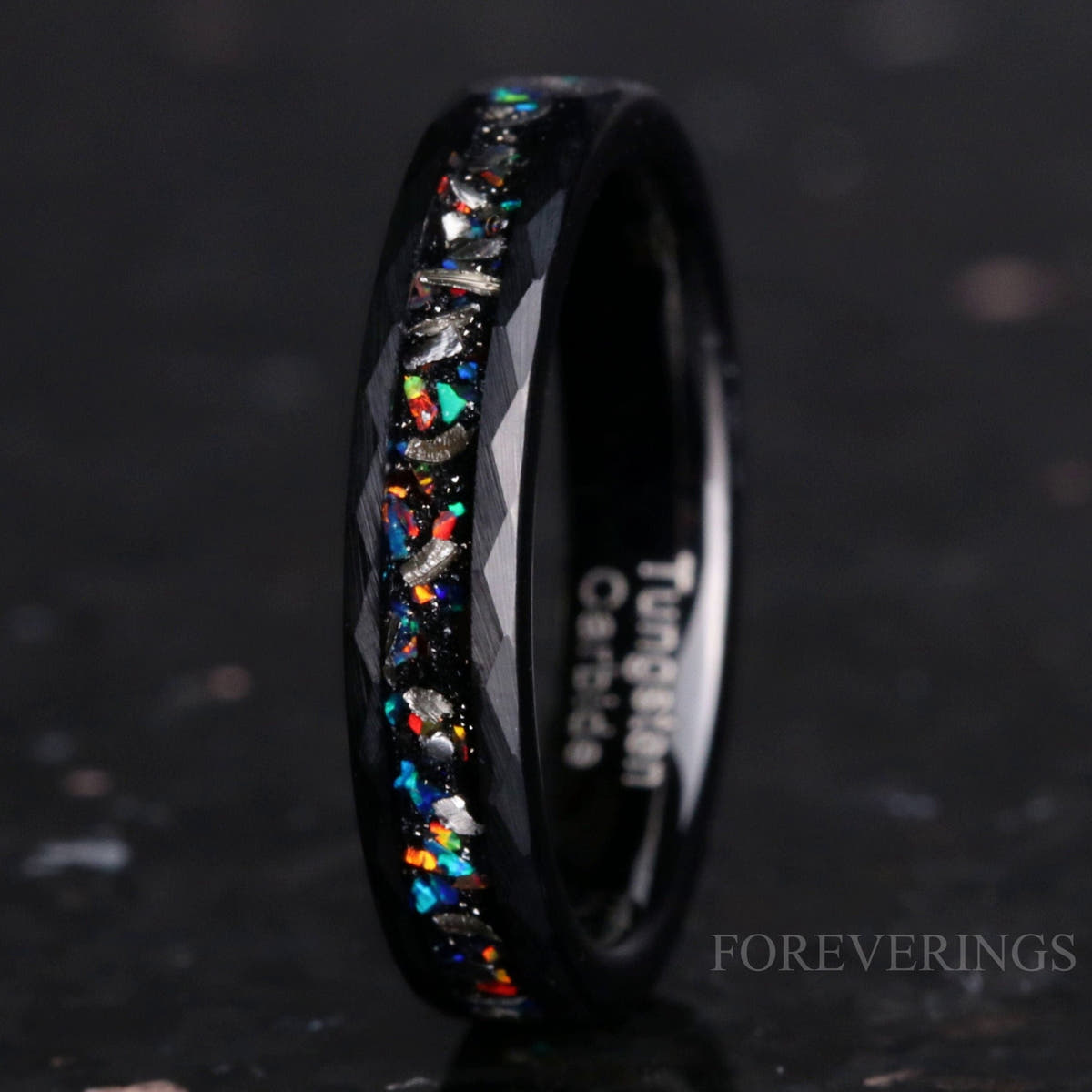 4mm hammered black tungsten wedding band with meteorite and galaxy opal inlay, standing on edge