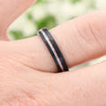 4mm black tungsten ring with a white fire opal stripe worn on a finger