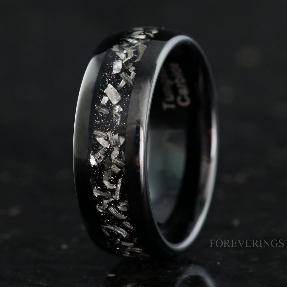 Men's 8mm black tungsten wedding band with a crushed meteorite inlay, polished dome